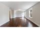 Open living area featuring hardwood floors, two windows, and neutral paint at 6490 Lake Esther Dr, Fairburn, GA 30213