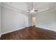 A spacious main bedroom features wood floors and a ceiling fan at 6490 Lake Esther Dr, Fairburn, GA 30213