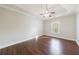 A well-lit main bedroom features wood floors and a ceiling fan at 6490 Lake Esther Dr, Fairburn, GA 30213