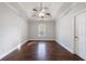 A well-lit main bedroom features wood floors and a ceiling fan at 6490 Lake Esther Dr, Fairburn, GA 30213