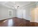 A well-lit main bedroom features wood floors, a ceiling fan, and a window at 6490 Lake Esther Dr, Fairburn, GA 30213