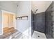 Bathroom with tiled walk-in shower, modern fixtures, and convenient built-in shelving at 6490 Lake Esther Dr, Fairburn, GA 30213