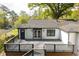 Backyard view featuring an expansive deck and manicured lawn, perfect for relaxation and entertainment at 1194 Clearview Ne Dr, Brookhaven, GA 30319