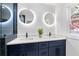 Stylish bathroom featuring double sinks, sleek fixtures, lighted mirrors, and a glass-enclosed shower at 1194 Clearview Ne Dr, Brookhaven, GA 30319