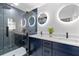Elegant bathroom with a glass-enclosed shower, stylish vanity, and modern, lighted mirrors at 1194 Clearview Ne Dr, Brookhaven, GA 30319