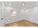A minimalist bedroom with hardwood floors and natural light streaming through the window at 1194 Clearview Ne Dr, Brookhaven, GA 30319