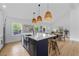 Bright kitchen featuring a large island with bar seating and stylish pendant lighting above at 1194 Clearview Ne Dr, Brookhaven, GA 30319