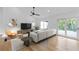 Bright living room with a modern sectional sofa, sleek furniture, and an adjacent outdoor space at 1194 Clearview Ne Dr, Brookhaven, GA 30319