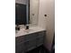 Modern bathroom featuring a sleek white vanity, contrasting black hardware, and a minimalist design at 2565 Cloud Ln, Decatur, GA 30034