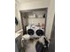 Functional laundry room features modern washer and dryer, storage shelf, and convenient toilet at 2565 Cloud Ln, Decatur, GA 30034
