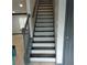 Staircase featuring wood stairs, grey trim and railings, and wood-look floors on the landing at 2565 Cloud Ln, Decatur, GA 30034