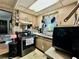 Compact kitchen with stainless steel appliances, wooden cabinetry, and sink at 6917 Laurelwood Dr, Douglasville, GA 30135