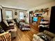 Cozy living room with hardwood floors, tv, recliner, and natural light at 6917 Laurelwood Dr, Douglasville, GA 30135