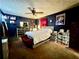 Bedroom featuring dark walls, ceiling fan, bed with white bedding, and bench at 6917 Laurelwood Dr, Douglasville, GA 30135