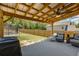 Covered patio with lounge seating and a grill, perfect for outdoor entertaining at 1661 Flagstone Ln, Conyers, GA 30012