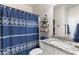 Bathroom with vanity, granite countertop, sink, toilet, and blue patterned shower curtain at 1661 Flagstone Ln, Conyers, GA 30012