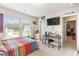 Bright bedroom featuring colorful bedding, large windows, and desk with chair at 1661 Flagstone Ln, Conyers, GA 30012