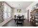Elegant dining room with a dark wood table, traditional decor, and plenty of natural light at 1661 Flagstone Ln, Conyers, GA 30012