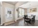 Bright dining room with wainscoting, large windows, and a modern chandelier at 1661 Flagstone Ln, Conyers, GA 30012