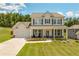 Charming two-story home with a welcoming front porch and manicured lawn at 1661 Flagstone Ln, Conyers, GA 30012
