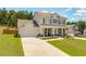 Inviting two-story home with a spacious driveway and manicured front yard at 1661 Flagstone Ln, Conyers, GA 30012