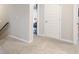 Hallway with beige carpet and door at 1661 Flagstone Ln, Conyers, GA 30012