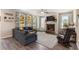 Inviting living room featuring a cozy fireplace, large sectional, and backyard views at 1661 Flagstone Ln, Conyers, GA 30012
