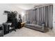 Living room features grey couch, curtains, media, and black desk at 1661 Flagstone Ln, Conyers, GA 30012