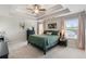Main bedroom with tray ceiling, carpet, ceiling fan, and windows with blinds at 1661 Flagstone Ln, Conyers, GA 30012