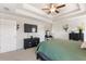 Main bedroom boasts a trey ceiling, ceiling fan, and black furniture at 1661 Flagstone Ln, Conyers, GA 30012