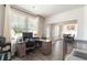 Home office boasts natural light, a modern desk, and a view into the dining room at 1661 Flagstone Ln, Conyers, GA 30012