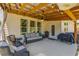 Inviting covered patio featuring comfortable seating, ceiling fan, and outdoor cooking space at 1661 Flagstone Ln, Conyers, GA 30012