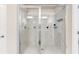 Large shower with marble tile and dual shower heads in the main bath at 1661 Flagstone Ln, Conyers, GA 30012