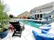 Spacious backyard featuring a stunning in-ground pool, slide, and comfortable lounge seating at 526 Rosemont Ave, Canton, GA 30115
