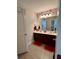 Bathroom featuring double sink vanity, decorative mirror, and accent lighting at 526 Rosemont Ave, Canton, GA 30115