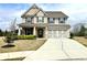 Charming two-story home with a manicured lawn, brick facade, and a welcoming front porch at 526 Rosemont Ave, Canton, GA 30115