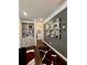 Hallway features hardwood floors, modern mirror wall art, and built-in shelving at 526 Rosemont Ave, Canton, GA 30115