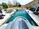 Full view of the pool with a slide, lounge chairs, and outdoor dining, set in a spacious backyard at 526 Rosemont Ave, Canton, GA 30115