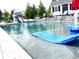 Resort-style pool with a slide, sun loungers, and lush greenery, perfect for relaxation and entertainment at 526 Rosemont Ave, Canton, GA 30115