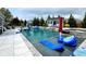 Stunning backyard pool with a slide, lounge chairs, and lush landscaping for ultimate relaxation at 526 Rosemont Ave, Canton, GA 30115