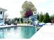 Inviting in-ground pool with a slide and lounge chairs, creating a relaxing backyard oasis at 526 Rosemont Ave, Canton, GA 30115