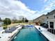 Backyard with a large in-ground pool, hot tub, and lounge area, perfect for entertaining guests at 526 Rosemont Ave, Canton, GA 30115