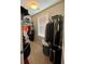 Walk-in closet features ample hanging space and storage options at 526 Rosemont Ave, Canton, GA 30115