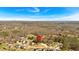 An aerial view of a scenic neighborhood surrounded by lush trees with mountain views in the background at 81 Bridgemill Dr, Douglasville, GA 30134