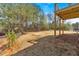 Large, graded backyard with a small deck, and bordered by mature trees and fencing at 81 Bridgemill Dr, Douglasville, GA 30134