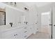 White bathroom with dual vanity, black hardware, and tile flooring at 81 Bridgemill Dr, Douglasville, GA 30134