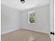 Bright bedroom featuring neutral walls, window and ceiling light fixture at 81 Bridgemill Dr, Douglasville, GA 30134