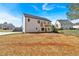 Rear view of a modern two-story home with a wooden deck and a graded, spacious backyard at 81 Bridgemill Dr, Douglasville, GA 30134