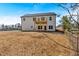 Back exterior of a two-story home featuring a wooden deck and a spacious backyard at 81 Bridgemill Dr, Douglasville, GA 30134