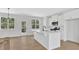 Bright kitchen boasts white cabinets, stainless appliances, and an island with a modern faucet at 81 Bridgemill Dr, Douglasville, GA 30134